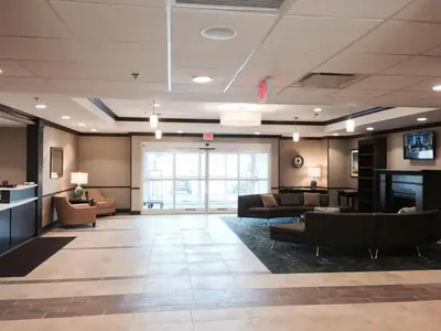 a large lobby with couches and chairs in a building at Candlewood Suites Youngstown W - I-80 Niles Area by IHG in Austintown