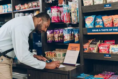 a man standing in a store looking at a shelf at Candlewood Suites Youngstown W - I-80 Niles Area by IHG in Austintown