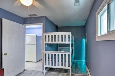 a room with a bunk bed and a blue wall at Lake Erie Waterfront Home with Sunroom and Yard! in Erie