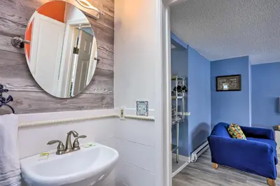 a bathroom with a sink and a mirror at Lake Erie Waterfront Home with Sunroom and Yard! in Erie