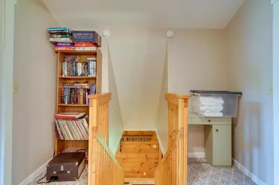 a room with a book shelf filled with books at Serene Mountain Retreat on 40 Acres with Fire Pit! in Bomont