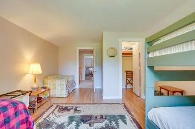 a bedroom with a bunk bed and a living room at Serene Mountain Retreat on 40 Acres with Fire Pit! in Bomont
