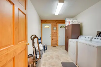 a kitchen with a refrigerator and a washer and dryer at Serene Mountain Retreat on 40 Acres with Fire Pit! in Bomont