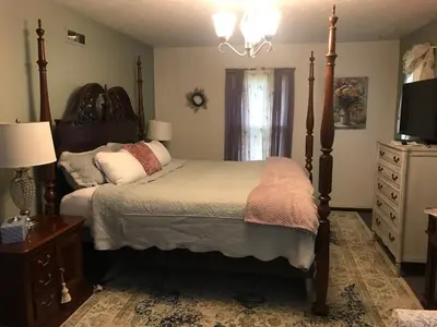 a bedroom with a bed and a television and a dresser at Hope Bed and Breakfast in Canton