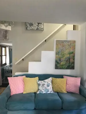 a living room with a blue couch with colorful pillows at Hope Bed and Breakfast in Canton