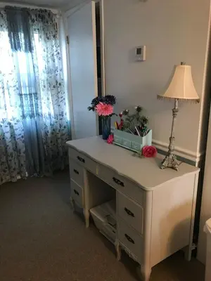 a white dresser with a lamp and flowers on it at Hope Bed and Breakfast in Canton