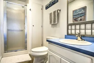 a bathroom with a toilet and a sink and a shower at Lakefront Home with Rooftop Deck, Grill, Games! in Hebron