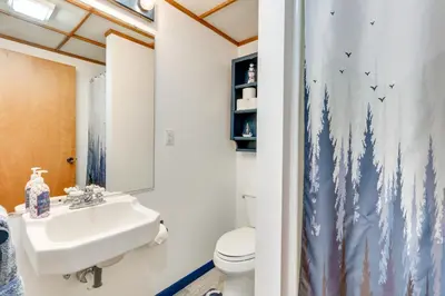 a bathroom with a sink and a toilet at Lakefront Home with Rooftop Deck, Grill, Games! in Hebron