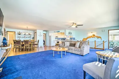 a living room with a couch and a table at Lakefront Home with Rooftop Deck, Grill, Games! in Hebron