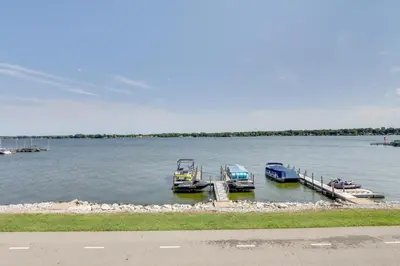 two boats are docked at a dock on a lake at Lakefront Home with Rooftop Deck, Grill, Games! in Hebron