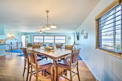 a dining room with a wooden table and chairs at Lakefront Home with Rooftop Deck, Grill, Games! in Hebron