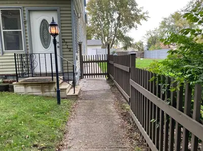 a street light in front of a house with a fence at **Stylish Pet Friendly 3 Bedroom House** in Cleveland