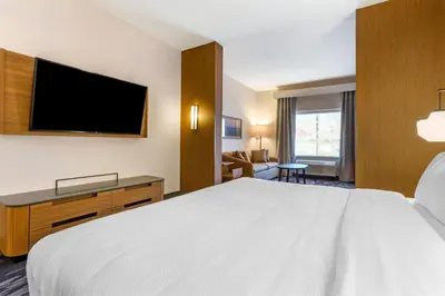 a hotel room with a bed and a flat screen tv at Fairfield by Marriott Inn & Suites Sandusky in Sandusky