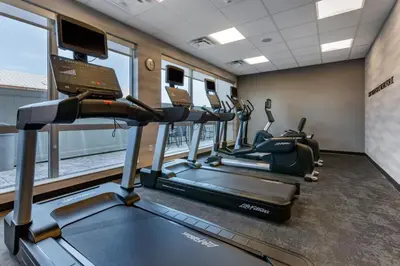 a gym with treadmills and ellipticals in a room at Fairfield by Marriott Inn & Suites Sandusky in Sandusky