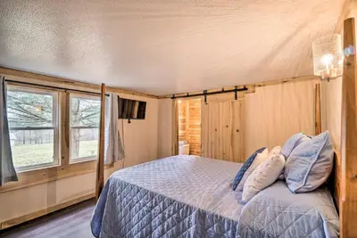 a bedroom with a bed and a window at Take 5 Retreat with Hot Tub Relax, Rest, Refresh! in Somerset