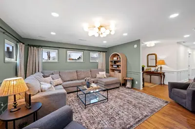 a living room with a couch and a table at Gather Together - Charming Home for 20 Near Ark! in Williamstown