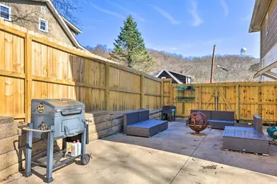 a backyard with a grill and a wooden fence at Pet-Friendly Covington Retreat with Fenced Yard in Covington