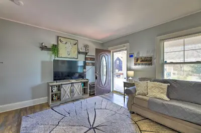 a living room with a couch and a flat screen tv at Pet-Friendly Covington Retreat with Fenced Yard in Covington
