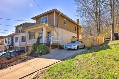 a house with a car parked in front of it at Pet-Friendly Covington Retreat with Fenced Yard in Covington