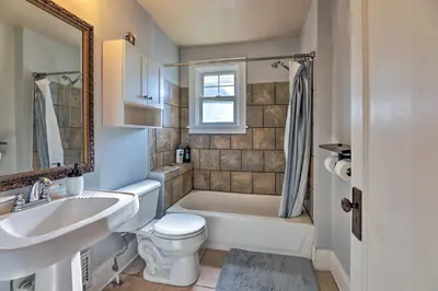 a bathroom with a tub and a sink and a toilet at Pet-Friendly Covington Retreat with Fenced Yard in Covington