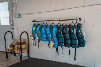 a wall with a bunch of blue bags hanging on a wall at Sandusky Bay Hot Tub, Gym, Patio, Games, Recreation Watercraft, Waterside Home, check it out! in Port Clinton
