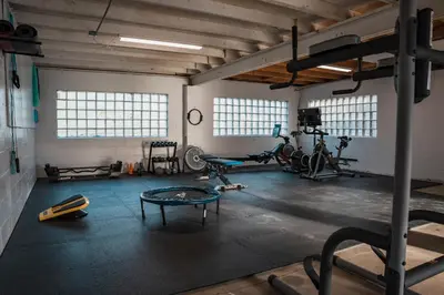 a gym with a bunch of equipment in a room at Sandusky Bay Hot Tub, Gym, Patio, Games, Recreation Watercraft, Waterside Home, check it out! in Port Clinton