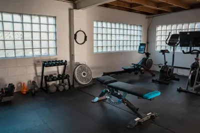 a gym with several different types of equipment in a room at Sandusky Bay Hot Tub, Gym, Patio, Games, Recreation Watercraft, Waterside Home, check it out! in Port Clinton