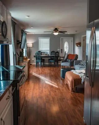 a kitchen and a living room with a table at Sandusky Bay Hot Tub, Gym, Patio, Games, Recreation Watercraft, Waterside Home, check it out! in Port Clinton