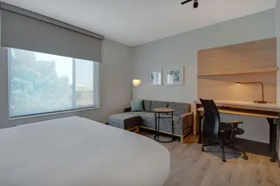 a hotel room with a bed and a desk and a chair at TownePlace Suites by Marriott Cincinnati Airport South in Florence