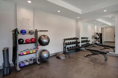 a gym with several exercise equipment and a mirror at TownePlace Suites by Marriott Cincinnati Airport South in Florence