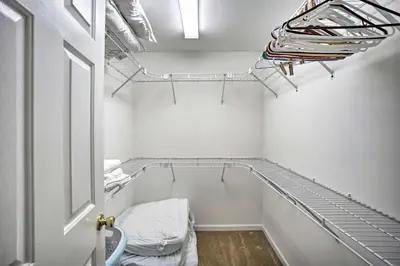a walk in closet with white walls and metal shelves at Delightful Tipp City Unit with Covered Patio! in Tipp City