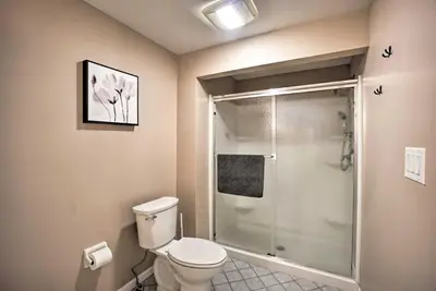 a bathroom with a toilet and a glass shower at Delightful Tipp City Unit with Covered Patio! in Tipp City