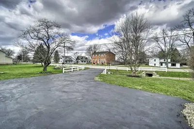 an empty driveway in a residential neighborhood with houses at Delightful Tipp City Unit with Covered Patio! in Tipp City