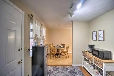 a kitchen and dining room with a refrigerator and a table at Delightful Tipp City Unit with Covered Patio! in Tipp City