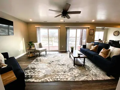 a living room with a couch and a ceiling fan at Harborview 3-6-8 on Main in Huron