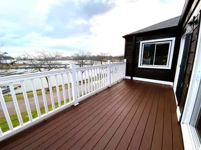 a wooden deck with a white fence on a house at Harborview 3-6-8 on Main in Huron