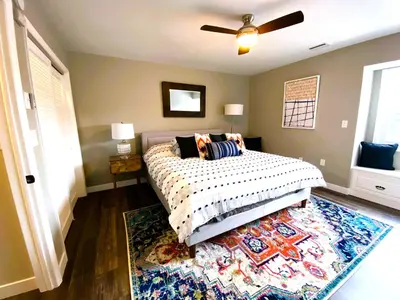 a bedroom with a bed and a rug at Harborview 3-6-8 on Main in Huron