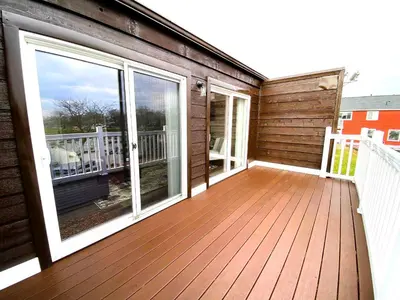 a large deck with sliding glass doors on a house at Harborview 3-6-8 on Main in Huron