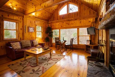 a living room with a couch and a table at Cherry Ridge Retreat Luxury Cabins in New Plymouth