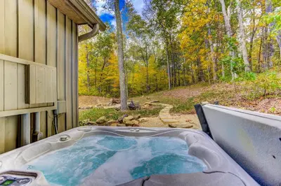a hot tub in the backyard of a house at Cherry Ridge Retreat Luxury Cabins in New Plymouth