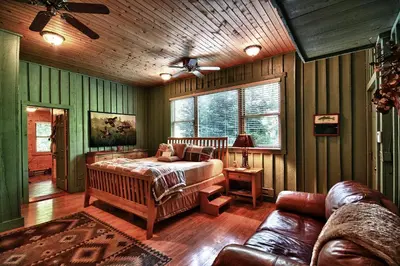 a bedroom with a bed and a couch at Cherry Ridge Retreat Luxury Cabins in New Plymouth