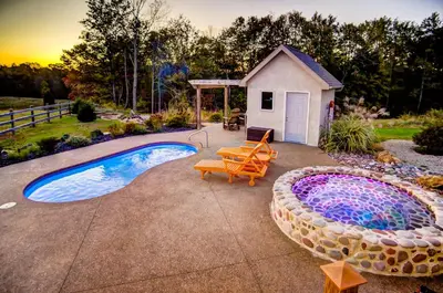 a backyard with a swimming pool and a sauna at Cherry Ridge Retreat Luxury Cabins in New Plymouth