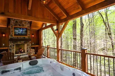 a large porch with a tub on a deck at Cherry Ridge Retreat Luxury Cabins in New Plymouth
