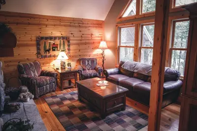 a living room with a couch and a table at Cherry Ridge Retreat Luxury Cabins in New Plymouth