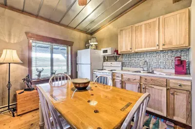 a kitchen with a wooden table and white appliances at Renovated Bunkhouse on 12-Acre Horse Farm! in Perrysville