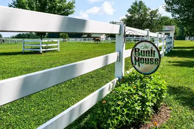 a white fence with a sign for a bump house at Renovated Bunkhouse on 12-Acre Horse Farm! in Perrysville