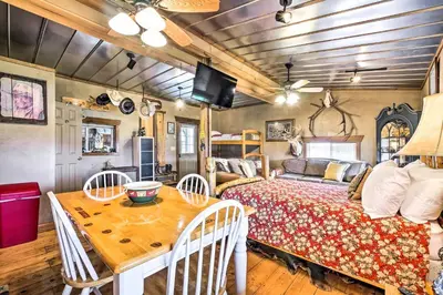 a bedroom with a bed and a table with chairs at Renovated Bunkhouse on 12-Acre Horse Farm! in Perrysville