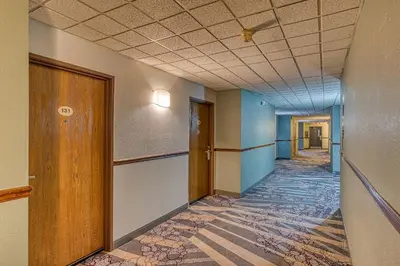 an empty hallway of an office with a ceiling at American Inn & suites in Dundee