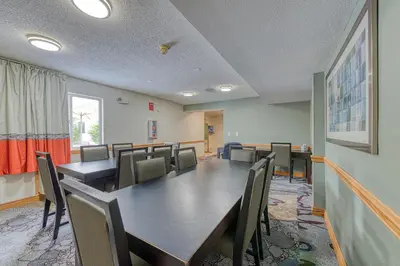 a conference room with a long table and chairs at American Inn & suites in Dundee