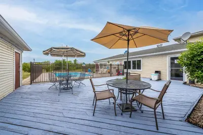 a patio with tables and chairs and umbrellas at American Inn & suites in Dundee